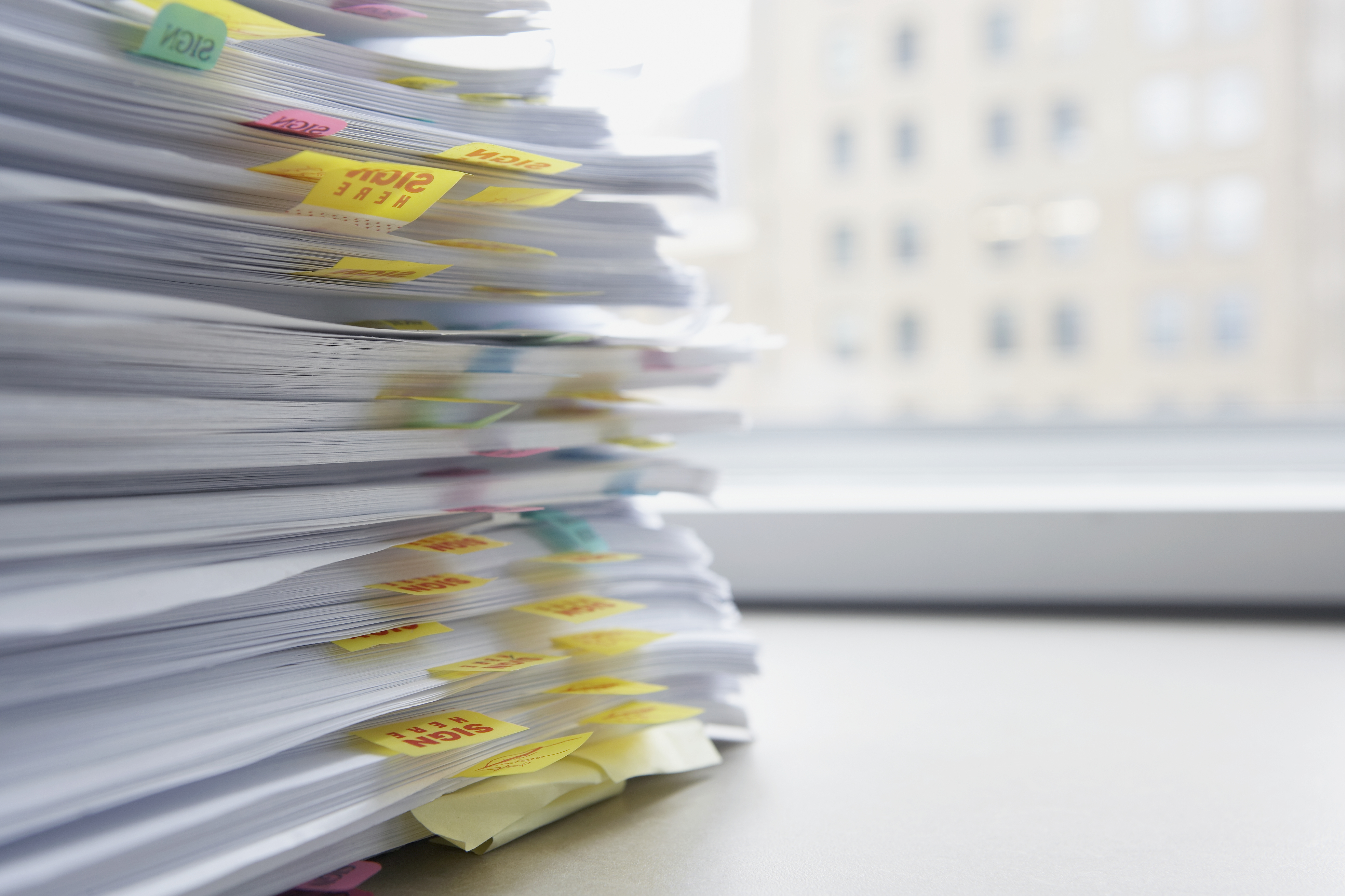 Stack_of_documents_on_desk_with_tabs