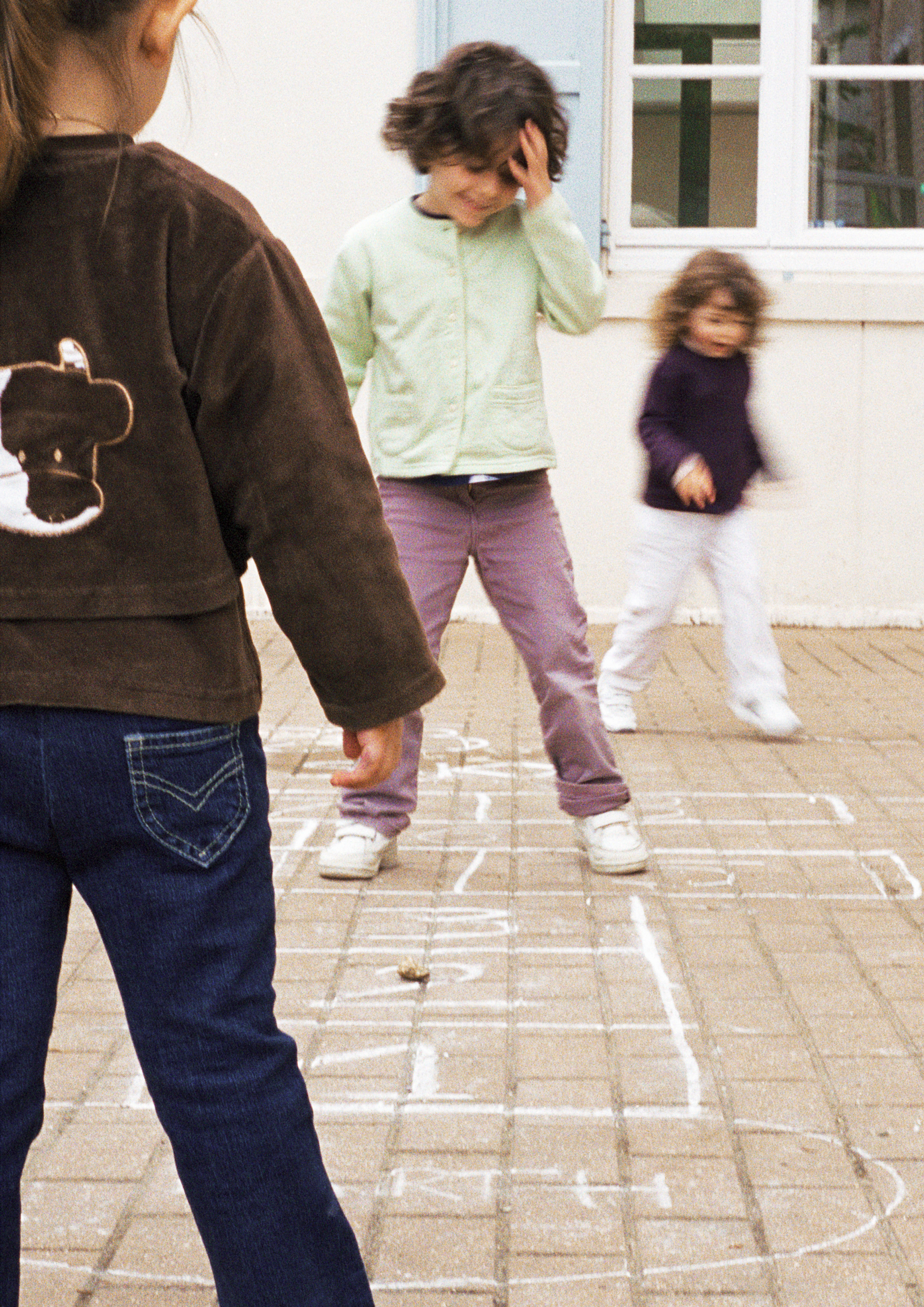Three_children_playing_hopscotch